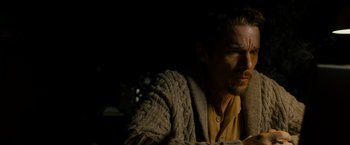 Movie still from “Sinister” (2012), directed by Scott Derrickson – A person wearing a sweater; Close Up shot, Low angle