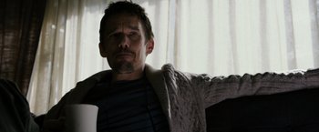 Movie still from “Sinister” (2012), directed by Scott Derrickson – A person wearing a sweater; Close Up shot, Low angle