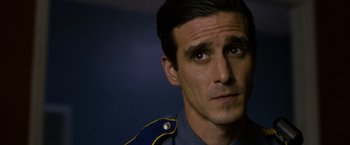 Movie still from “Sinister” (2012), directed by Scott Derrickson – A person wearing a uniform; Close Up shot, Over the shoulder angle