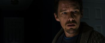 Movie still from “Sinister” (2012), directed by Scott Derrickson – A man's face in the dark; Close Up shot, Low angle