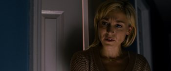 Movie still from “Sinister” (2012), directed by Scott Derrickson – A person wearing a brown sweater; Close Up shot, Over the shoulder angle