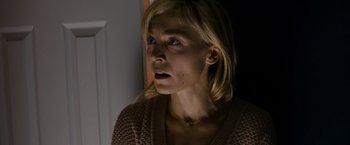 Movie still from “Sinister” (2012), directed by Scott Derrickson – A woman with blonde long hair looking at the camera; Close Up shot, Over the shoulder angle