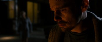 Movie still from “Sinister” (2012), directed by Scott Derrickson – A person looking down at his face; Close Up shot, Low angle