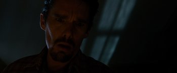 Movie still from “Sinister” (2012), directed by Scott Derrickson – A person looking at the camera; Close Up shot, Low angle