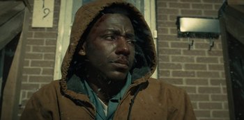 A black man with blood all over his face