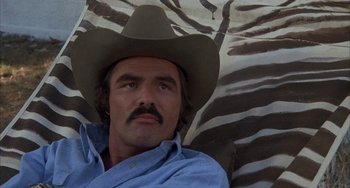 Movie still from “Smokey and the Bandit” (1977), directed by Hal Needham – A man with a mustache wearing a cowboy hat; Close Up shot, Low angle