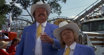 Movie still from “Smokey and the Bandit” (1977), directed by Hal Needham – A couple of men in blue jackets and white cowboy hats; Medium shot, Low angle