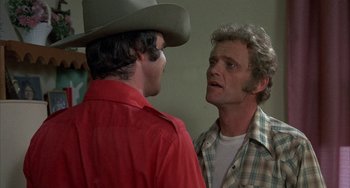 Movie still from “Smokey and the Bandit” (1977), directed by Hal Needham – Two men are talking to each other while wearing cowboy hats; Close Up shot, Over the shoulder angle
