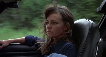 Movie still from “Smokey and the Bandit” (1977), directed by Hal Needham – A woman sitting in the back seat of a car; Close Up shot, Low angle