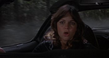 Movie still from “Smokey and the Bandit” (1977), directed by Hal Needham – A woman in a car with her mouth wide open; Close Up shot, Over the shoulder angle