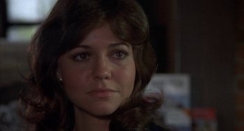 Movie still from “Smokey and the Bandit” (1977), directed by Hal Needham – A person with long brown hair; Close Up shot, Over the shoulder angle