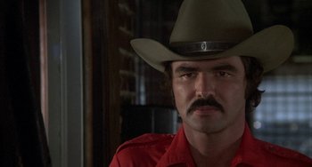 Movie still from “Smokey and the Bandit” (1977), directed by Hal Needham – A person wearing a cowboy hat; Close Up shot, Over the shoulder angle