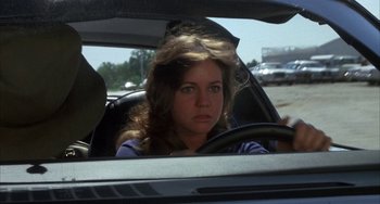 Movie still from “Smokey and the Bandit” (1977), directed by Hal Needham – A woman sitting in the driver's seat of a car; Close Up shot, Over the shoulder angle