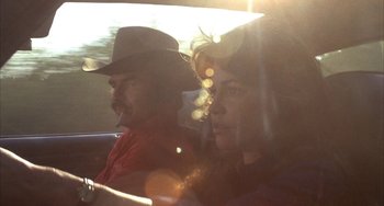 Movie still from “Smokey and the Bandit” (1977), directed by Hal Needham – A man and a woman sitting in a car; Close Up shot, Low angle
