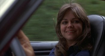 Movie still from “Smokey and the Bandit” (1977), directed by Hal Needham – A woman sitting in the back seat of a car; Close Up shot, Over the shoulder angle