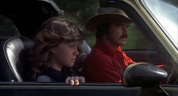 Movie still from “Smokey and the Bandit” (1977), directed by Hal Needham – A man and a woman sitting in the back of a car; Close Up shot, Low angle