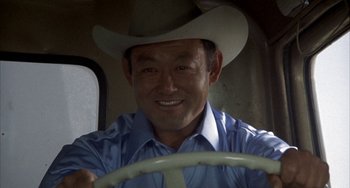Movie still from “Smokey and the Bandit” (1977), directed by Hal Needham – A man wearing a cowboy hat sitting in the driver's seat of a vehicle; Close Up shot, Low angle