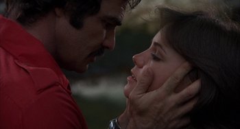 Movie still from “Smokey and the Bandit” (1977), directed by Hal Needham – A man and a woman face to face in a park; Close Up shot, Low angle