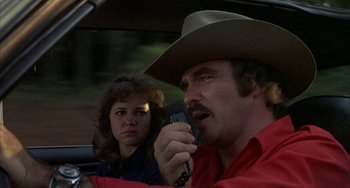 Movie still from “Smokey and the Bandit” (1977), directed by Hal Needham – A man and a woman in the back of a car; Close Up shot, Over the shoulder angle