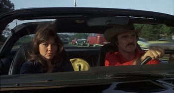 Movie still from “Smokey and the Bandit” (1977), directed by Hal Needham – A man and a woman sitting in the back of a car; Close Up shot, Low angle