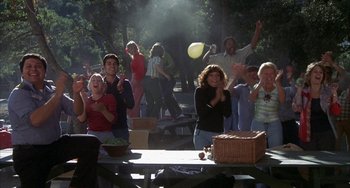 Movie still from “Smokey and the Bandit” (1977), directed by Hal Needham – A group of people sitting at a picnic table; Wide shot, High angle