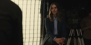 Movie still from “Somebody I Used to Know” (2023), directed by Dave Franco – A woman sitting in a chair in front of a window; Medium shot, Low angle