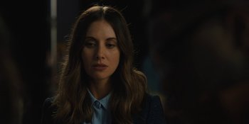 Movie still from “Somebody I Used to Know” (2023), directed by Dave Franco – A beautiful woman with long brown hair wearing a blue shirt; Close Up shot, Over the shoulder angle