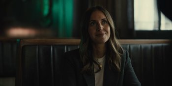 Movie still from “Somebody I Used to Know” (2023), directed by Dave Franco – A woman sitting in front of a green wall; Close Up shot, Over the shoulder angle