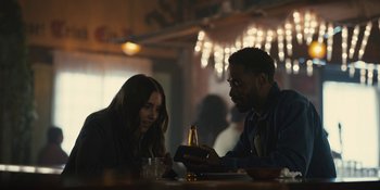 Movie still from “Somebody I Used to Know” (2023), directed by Dave Franco – A man and a woman looking at a cell phone; Medium shot, Over the shoulder angle