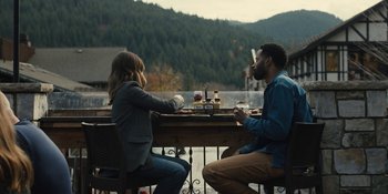 Movie still from “Somebody I Used to Know” (2023), directed by Dave Franco – A man and a woman sitting at a table with wine glasses; Wide shot, High angle