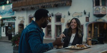 Movie still from “Somebody I Used to Know” (2023), directed by Dave Franco – A man and a woman sitting at an outdoor table; Medium shot, Over the shoulder angle