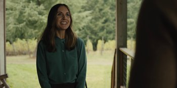 Movie still from “Somebody I Used to Know” (2023), directed by Dave Franco – A woman standing on a porch looking up at the sky; Medium shot, Over the shoulder angle