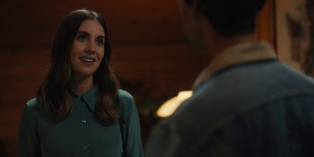 Movie still from “Somebody I Used to Know” (2023), directed by Dave Franco – A woman standing next to a man in a room; Close Up shot, Over the shoulder angle