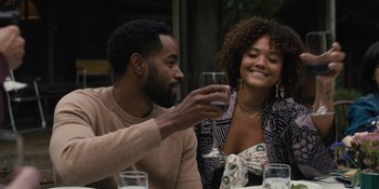 Movie still from “Somebody I Used to Know” (2023), directed by Dave Franco – A man and a woman sitting at a table with a glass of wine; Medium shot, Over the shoulder angle