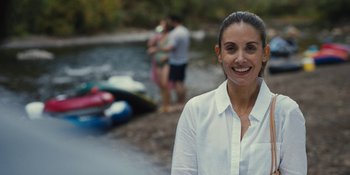 Movie still from “Somebody I Used to Know” (2023), directed by Dave Franco – A woman standing in front of a body of water; Close Up shot, Over the shoulder angle