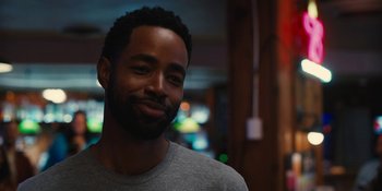 Movie still from “Somebody I Used to Know” (2023), directed by Dave Franco – A person smiling at the camera; Close Up shot, Over the shoulder angle