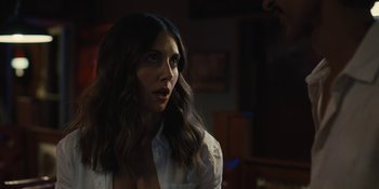 Movie still from “Somebody I Used to Know” (2023), directed by Dave Franco – A woman in a white shirt is looking at the camera; Close Up shot, Over the shoulder angle