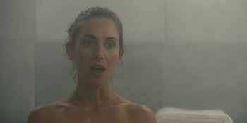 Movie still from “Somebody I Used to Know” (2023), directed by Dave Franco – A beautiful woman with a bare chest looking into a mirror; Close Up shot, Over the shoulder angle