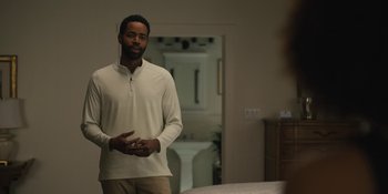 Movie still from “Somebody I Used to Know” (2023), directed by Dave Franco – A man standing in front of a bed in a room; Medium shot, Over the shoulder angle