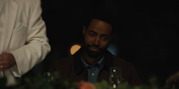 Movie still from “Somebody I Used to Know” (2023), directed by Dave Franco – A person sitting at a dinner table; Close Up shot, Over the shoulder angle