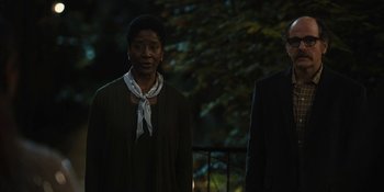 Movie still from “Somebody I Used to Know” (2023), directed by Dave Franco – A woman standing next to a man wearing a suit; Medium shot, Low angle