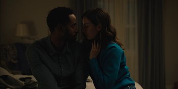 Movie still from “Somebody I Used to Know” (2023), directed by Dave Franco – A man and a woman sitting next to each other in a room; Medium shot, High angle