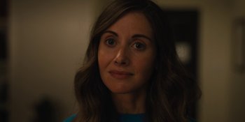 Movie still from “Somebody I Used to Know” (2023), directed by Dave Franco – A woman's face in the dark; Close Up shot, Over the shoulder angle
