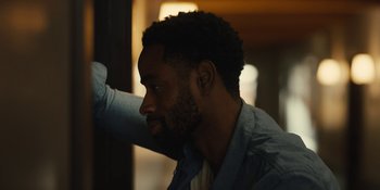 Movie still from “Somebody I Used to Know” (2023), directed by Dave Franco – A person sitting in a room; Close Up shot, Over the shoulder angle