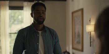 Movie still from “Somebody I Used to Know” (2023), directed by Dave Franco – A man standing in front of a mirror in a living room; Medium shot, Over the shoulder angle