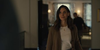 Movie still from “Somebody I Used to Know” (2023), directed by Dave Franco – A woman standing in front of a window in a room; Medium shot, Over the shoulder angle
