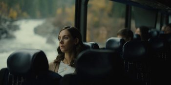 Movie still from “Somebody I Used to Know” (2023), directed by Dave Franco – A woman sitting on a bus looking out the window; Close Up shot, Over the shoulder angle