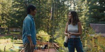 Movie still from “Somebody I Used to Know” (2023), directed by Dave Franco – A man and a woman standing next to each other on a deck; Medium shot, Over the shoulder angle