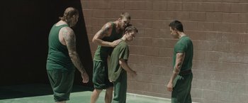 Movie still from “Son of a Gun” (2014), directed by Julius Avery – A group of young men standing next to each other; Wide shot, High angle