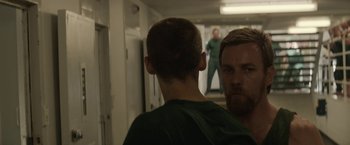 Movie still from “Son of a Gun” (2014), directed by Julius Avery – A man in a green shirt looking at another man in a green shirt; Medium shot, Over the shoulder angle